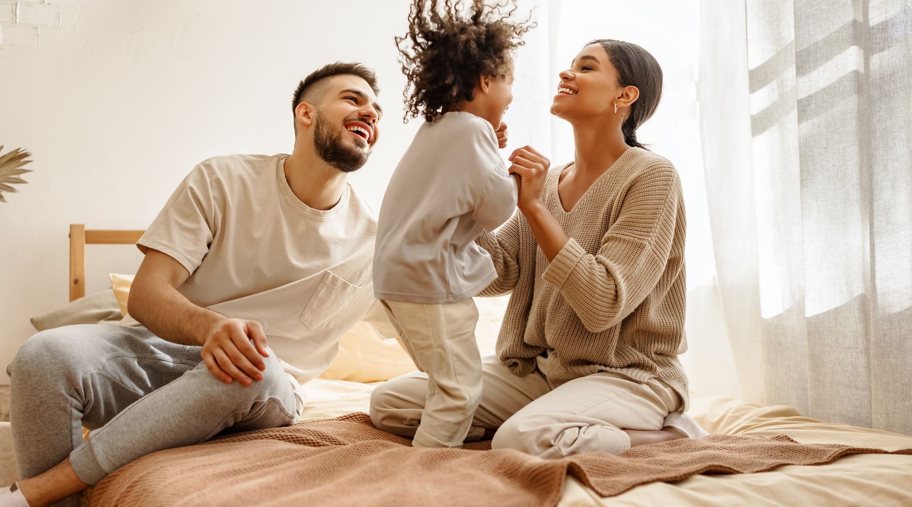 a family embracing in a bedroom